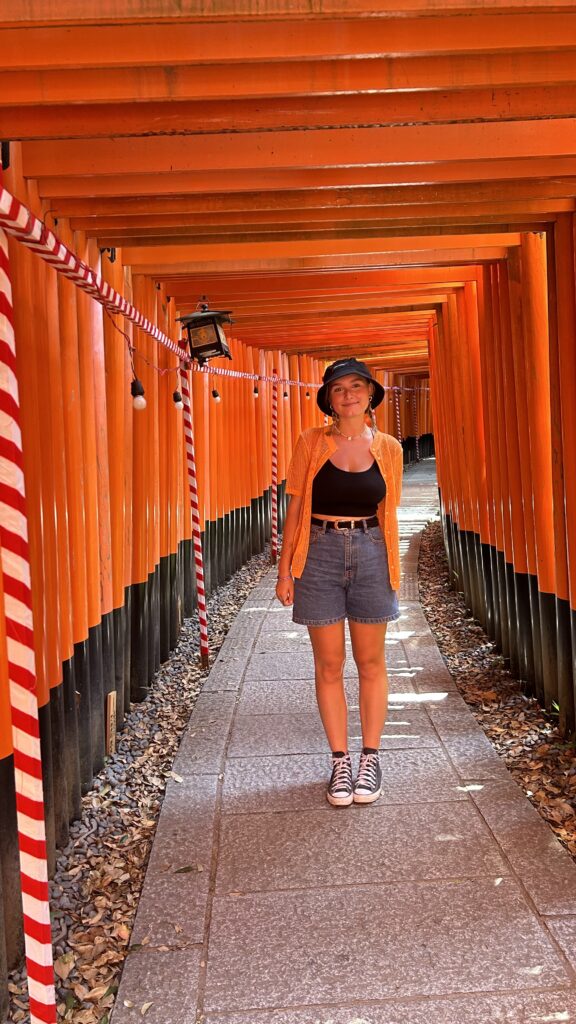 Young woman stood in red shrine